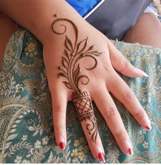 a woman's hand with hennap on her left arm and the ring finger