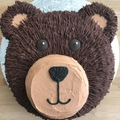 a cake shaped like a teddy bear with chocolate frosting on it's face