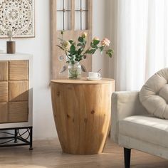 a living room with a chair, table and vase