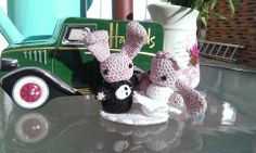 two crocheted stuffed animals sitting on top of a table next to a toy truck