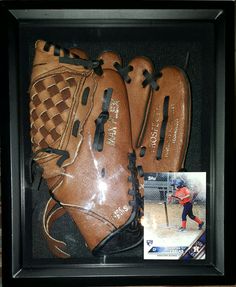 a baseball glove in a shadow box with an image of the catcher's mitt