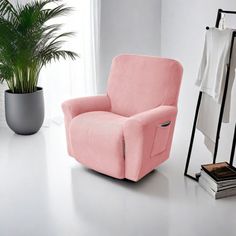 a pink chair sitting next to a potted plant