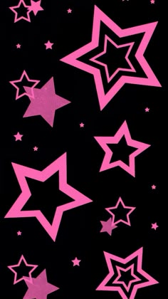 pink and black stars are flying in the air