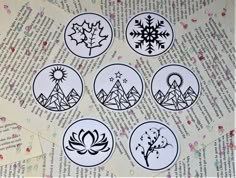 six stickers with different designs on them sitting on top of a piece of paper