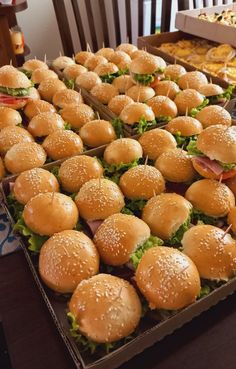 several trays of hamburgers sitting on top of a table