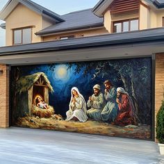 a painting on the side of a garage door depicting three people and a baby jesus