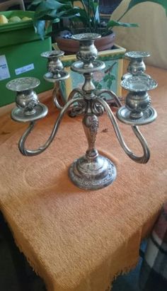 a silver candelabra sitting on top of a table