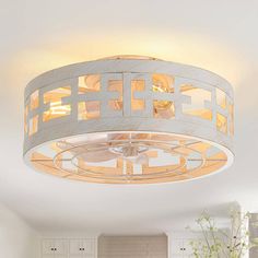 a white circular light fixture in a kitchen