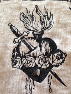 a black and white drawing of roses on a piece of cloth with scissors in it