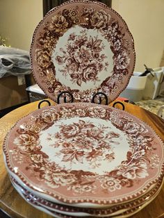 a stack of plates sitting on top of a wooden table