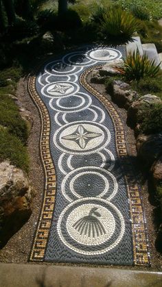 a pathway made out of stones with circles and stars on it