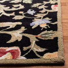 a black rug with floral designs on it