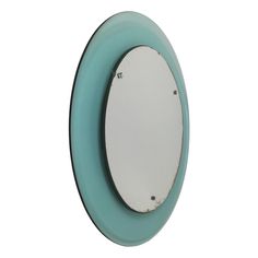 a white and blue oval mirror on a wall