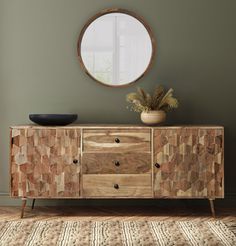 a wooden sideboard with two drawers and a round mirror on the wall