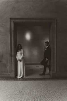 a man and woman standing in an elevator