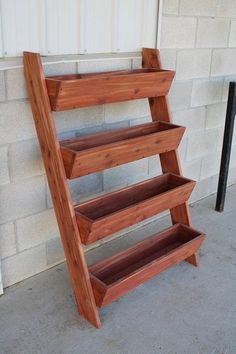 a wooden shelf sitting on the side of a building