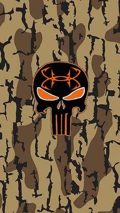 an orange and black skull on a camouflage background