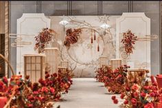 an elaborately decorated ceremony set up with red flowers