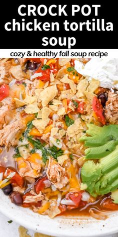 chicken tortilla soup in a white bowl with avocado and cilantro