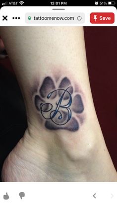 a foot with a dog paw and the letter b tattooed on it's side