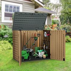 a garden shed with gardening equipment in the back and lawn mowers on the side