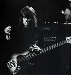 a black and white photo of a bass player