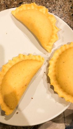 three pieces of pie sitting on top of a white plate