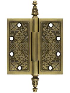 an antique brass plated door hinge with decorative designs on the front and sides