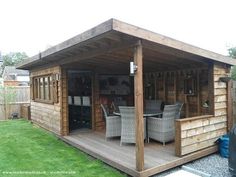 a wooden shed with chairs and tables on it