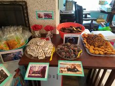 a table topped with lots of desserts and pastries