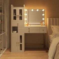 a white vanity with lights on it in a bedroom next to a bed and mirror