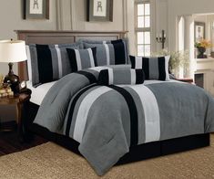 a bed with black and white striped comforters