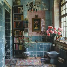 a bathroom with blue tiles and pink flowers