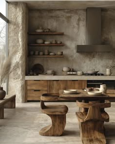 a wooden table sitting in the middle of a kitchen next to an oven and counter top