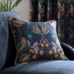 a blue couch with a decorative pillow on it