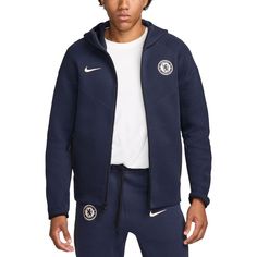 a young man wearing a nike jacket and sweatpants with the chelsea crest on it