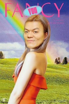 a woman in an orange dress with a rainbow behind her