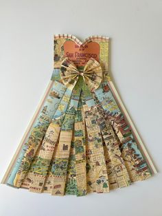 a dress made out of maps with a bow