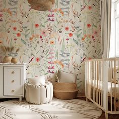 a baby's room with floral wallpaper and a crib