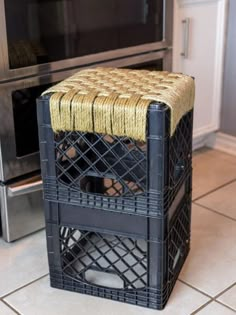 a kitchen with a stove and microwave in the background that has a basket on top of it