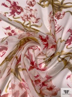 a close up view of a pink and gold floral print chiffon fabric