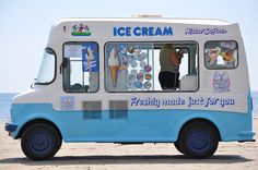 an ice cream truck is parked on the beach