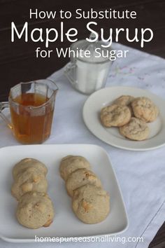 white sugar cookies on a plate next to a glass of tea