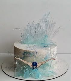 there is a cake that has been frosted with blue and white icing on it