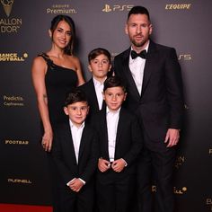 a family posing for a photo on the red carpet