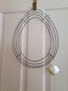 a white door with a black wire circle hanging on it