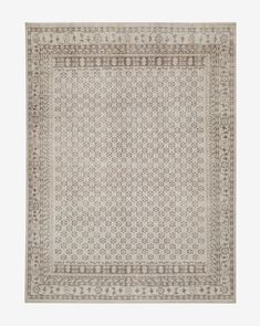 a beige and white rug with an intricate design on the bottom, in front of a white background