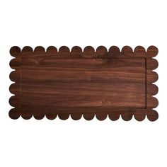 a wooden cutting board with scalloped edges