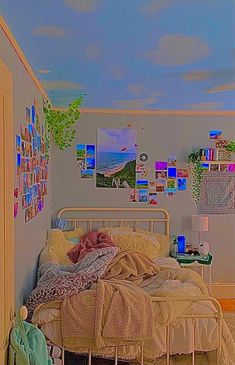 a bed room with a neatly made bed and lots of pictures on the wall above it