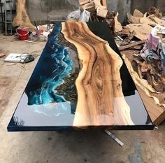 a table made out of wood and glass is shown in the process of being finished